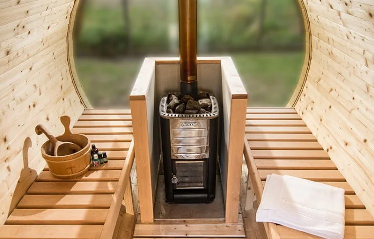 Barrel sauna interior with Harvia wood stove